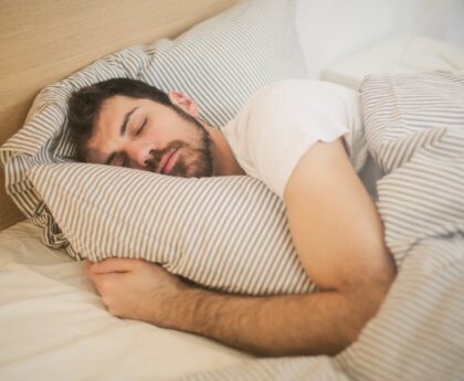 Person sleeping peacefully after treating sleep apnea through weight loss and lifestyle changes