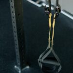 Person performing slow eccentric lowering phase of a dumbbell curl for muscle building