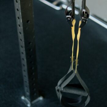 Person performing slow eccentric lowering phase of a dumbbell curl for muscle building