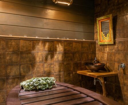 Person entering cold plunge ice bath after sauna for contrast therapy recovery